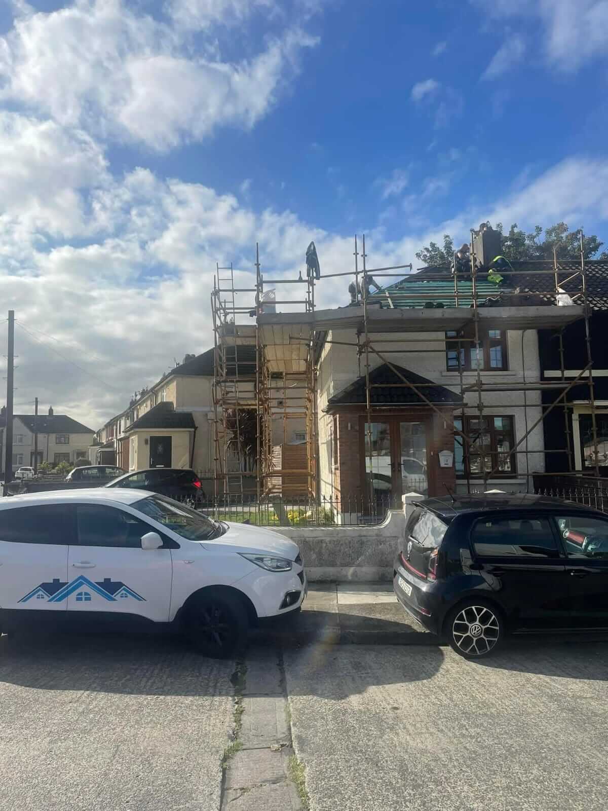 roofers putting a new roof on a house on scaffold